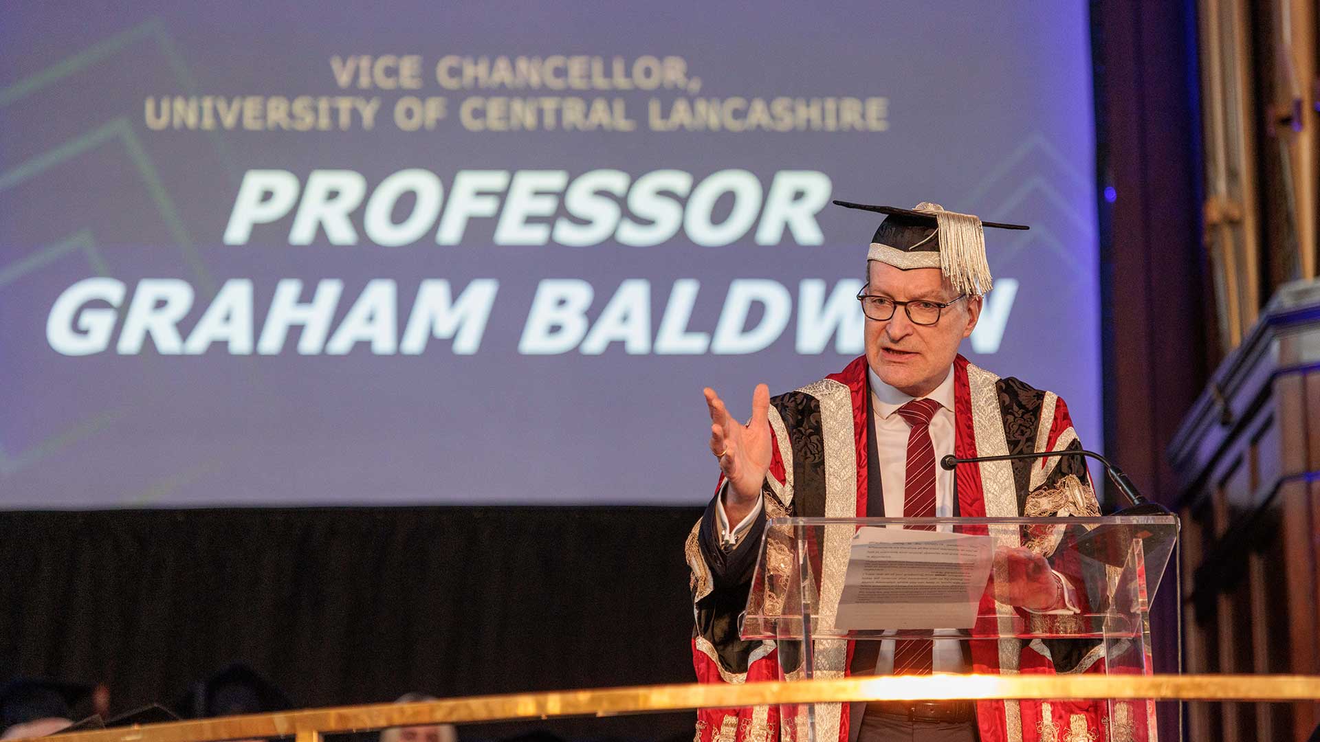 Hugh Baird lecturerer presenting at a graduation