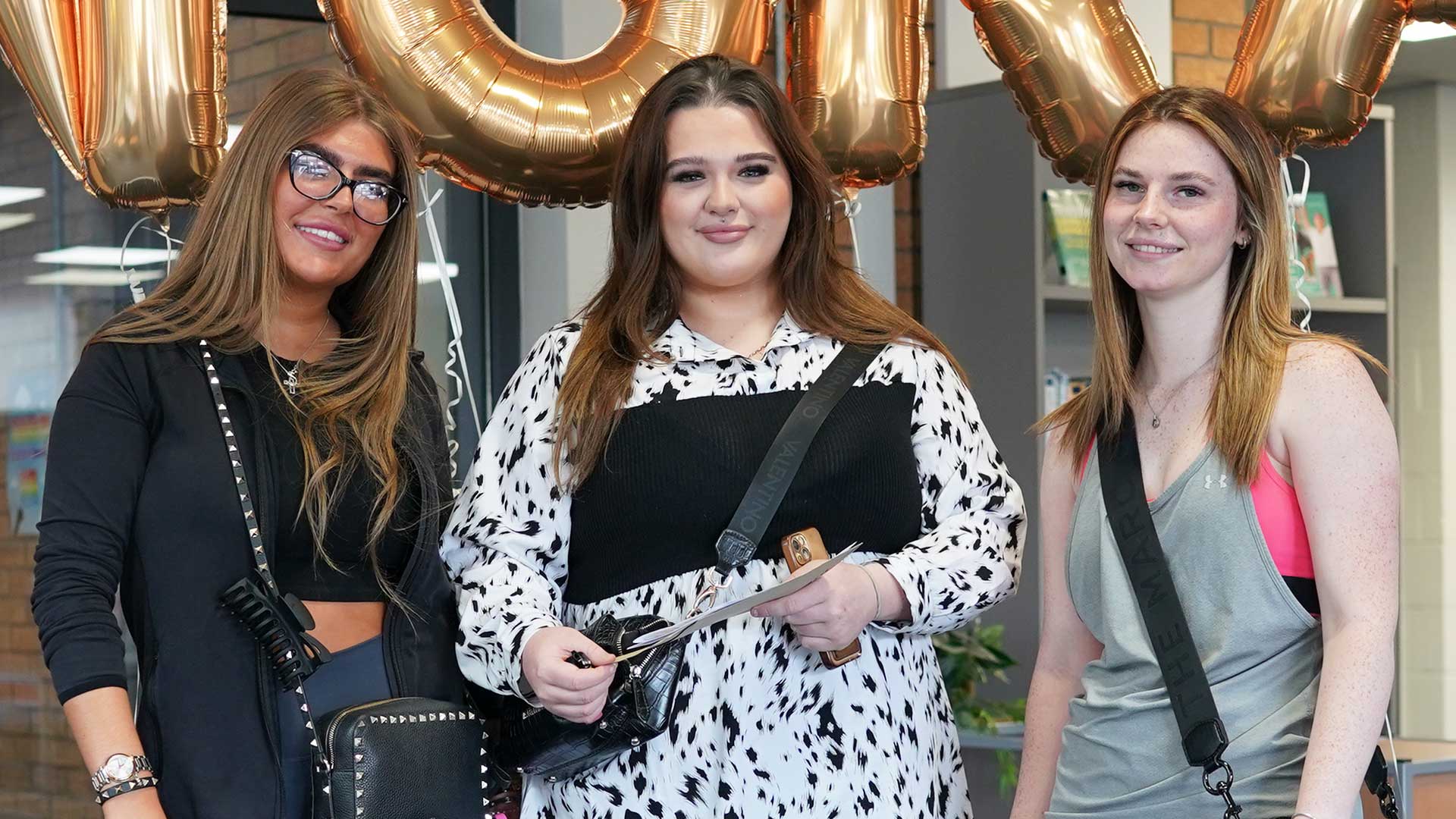 Sadie Morris (left), Annie Mouat (centre) and Paige Gallogley receive their results.